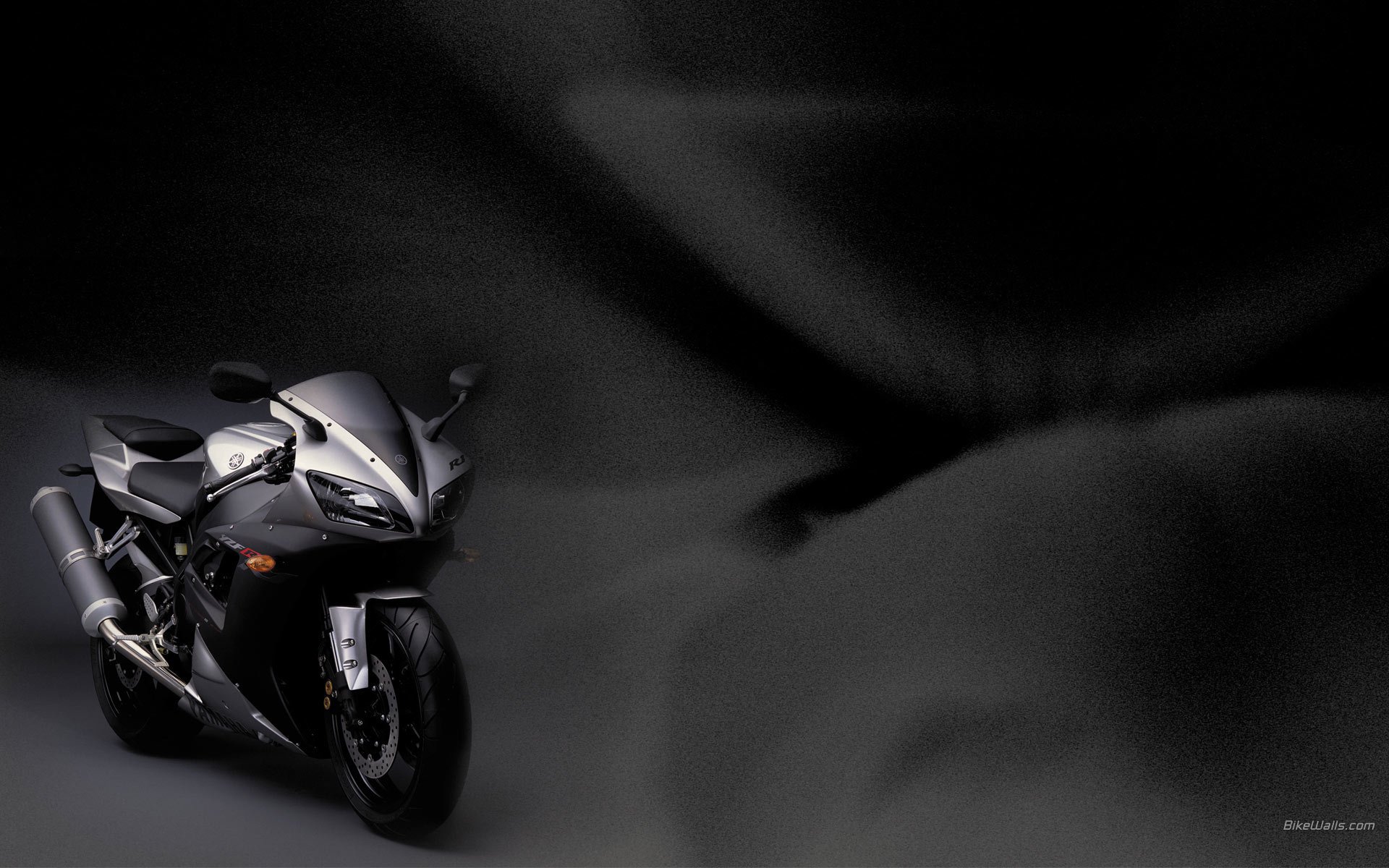 Stylish silver motorcycle on a dark background