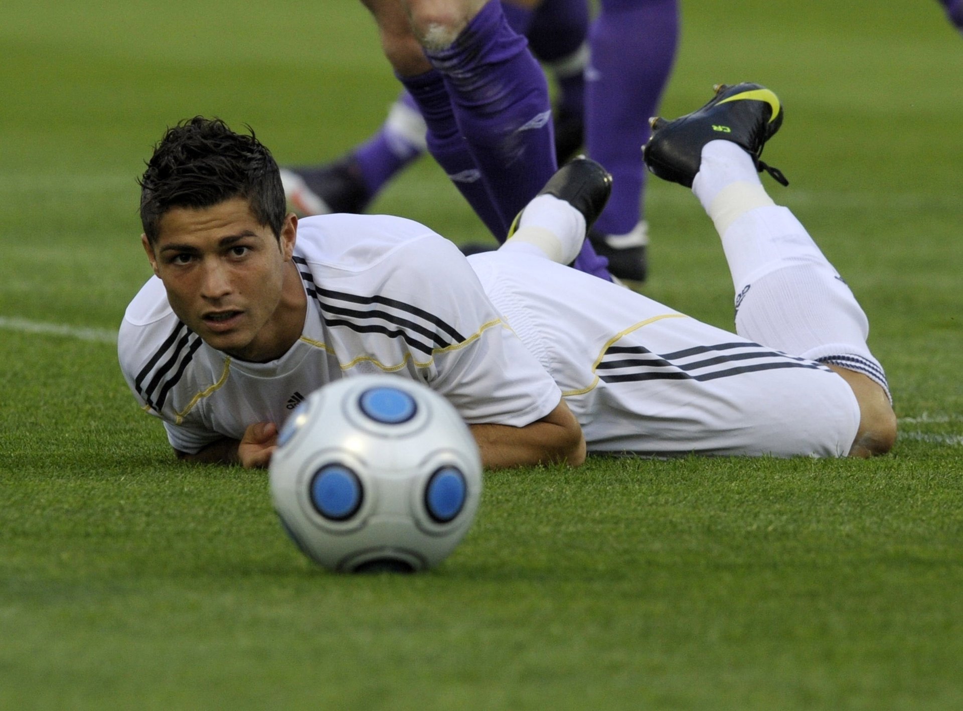 A football game. Ronaldo is lying on the lawn