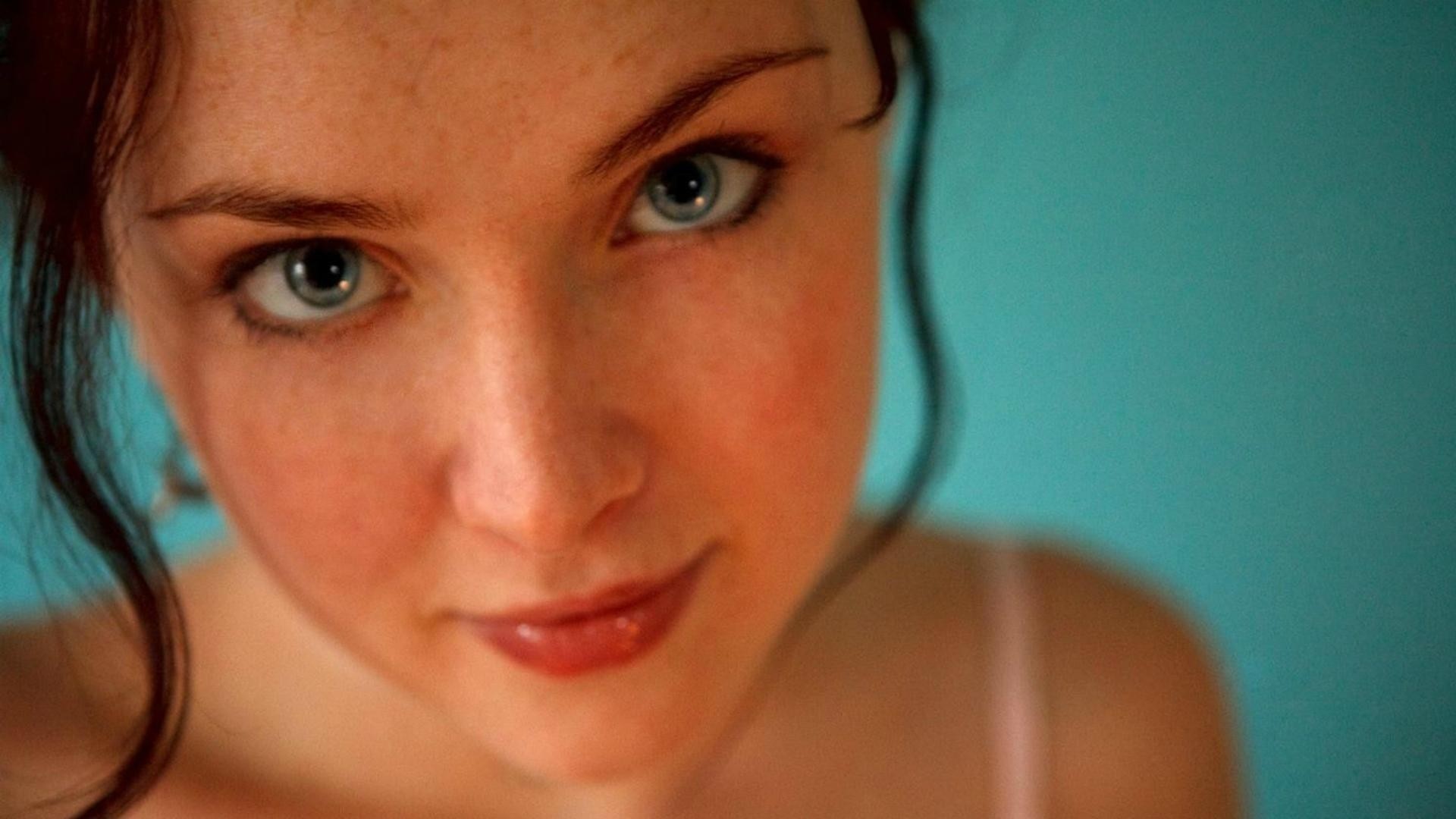a woman girl brunette blue close up face