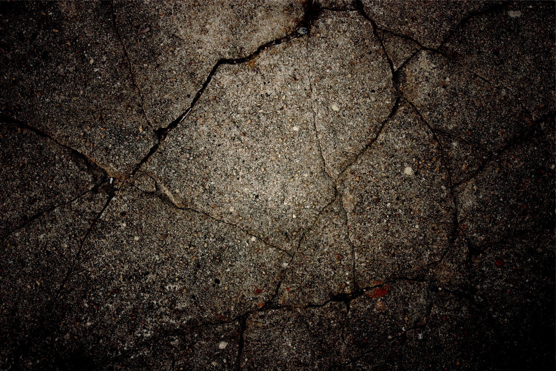 Cracks on the asphalt. Cracks on the wall