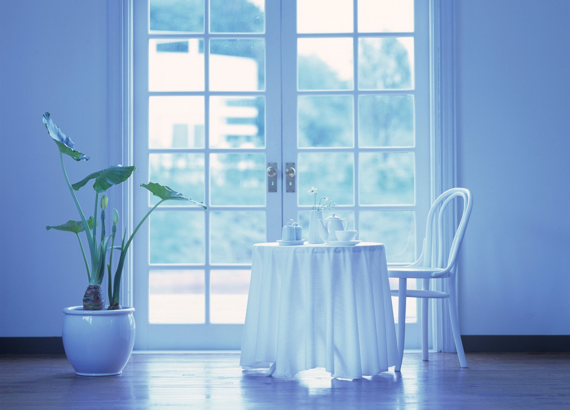 A table with a white tablecloth by the door