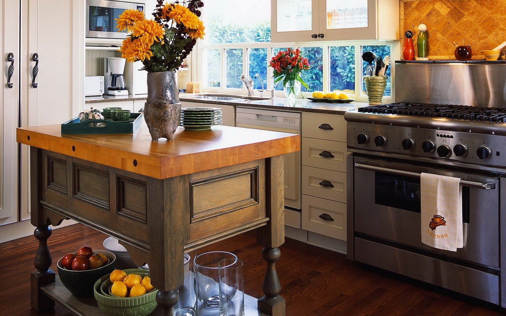 Cozy kitchen with bright flowers in vases