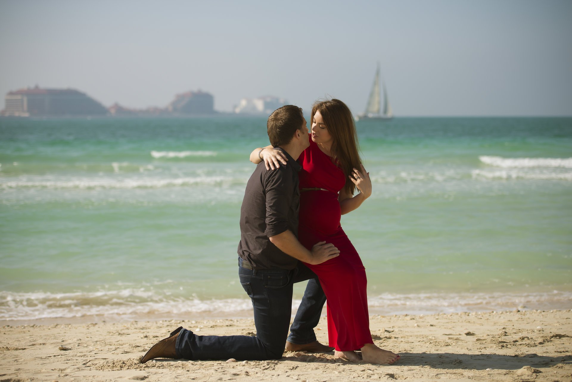girl guy young man sea beach sand sailboats landscape .