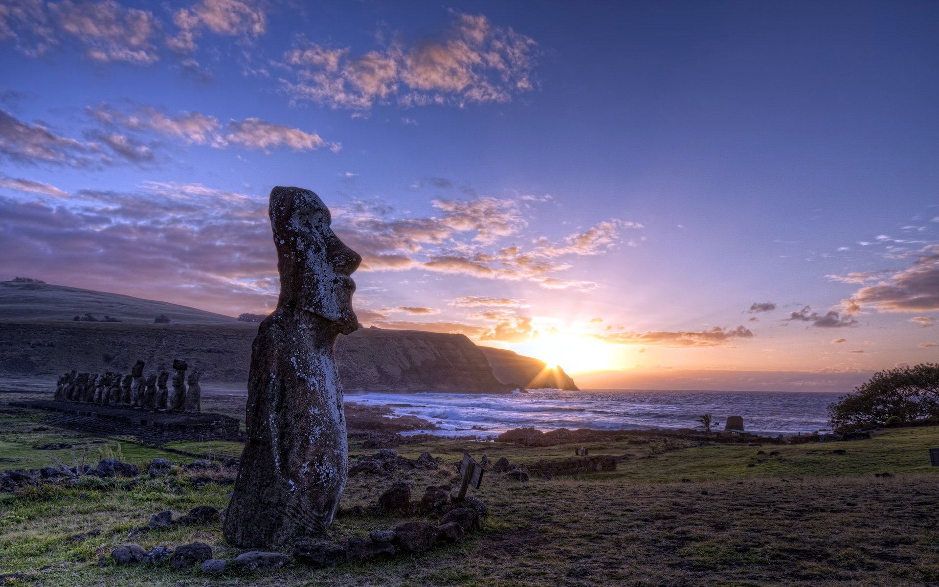 Idols on the island against the sunset