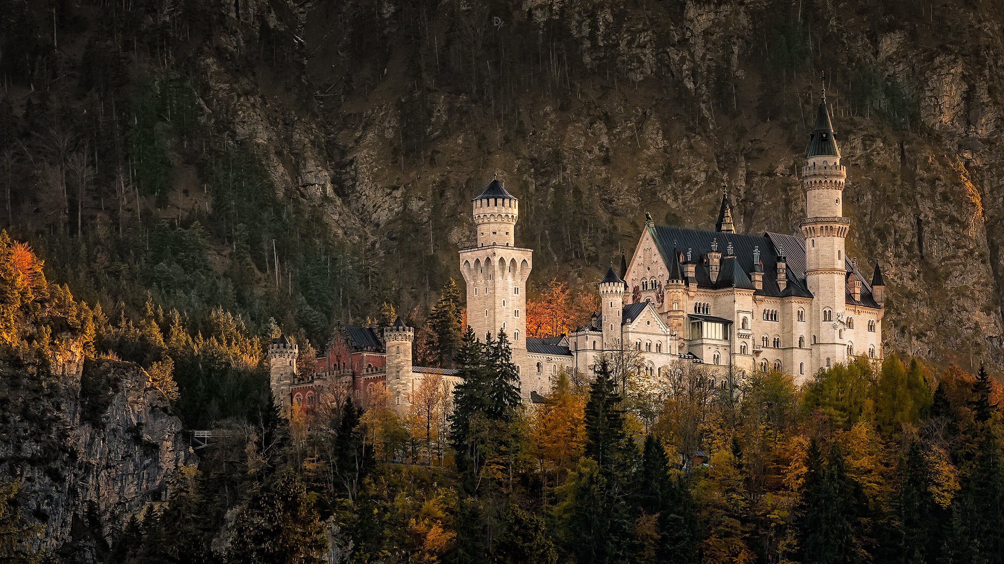 Neuschwanstein Castle On The Background Of Autumn Forest And Mountains