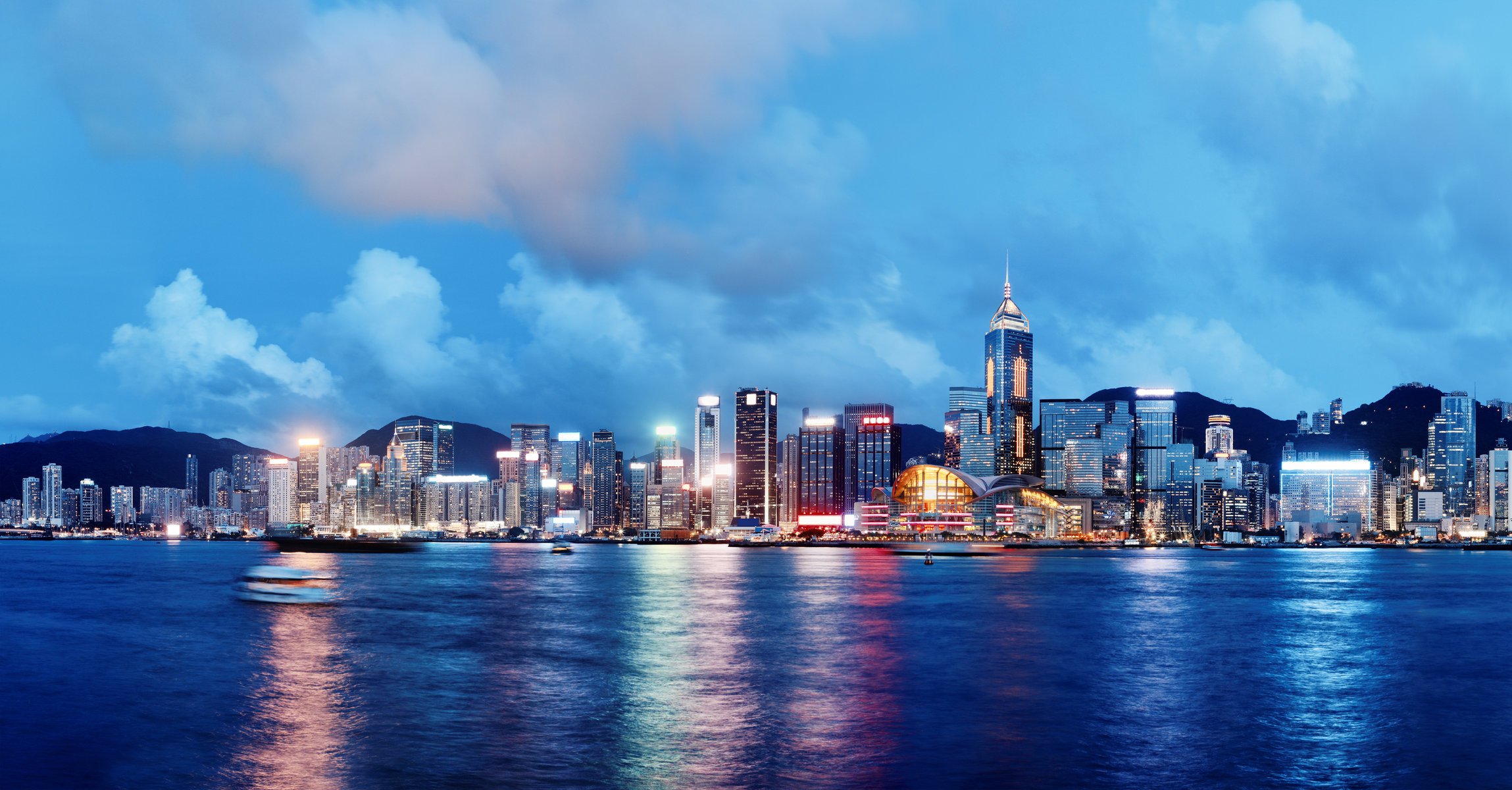 hong kong china city skyline lights sea river night ships buildings sky clouds town horizon