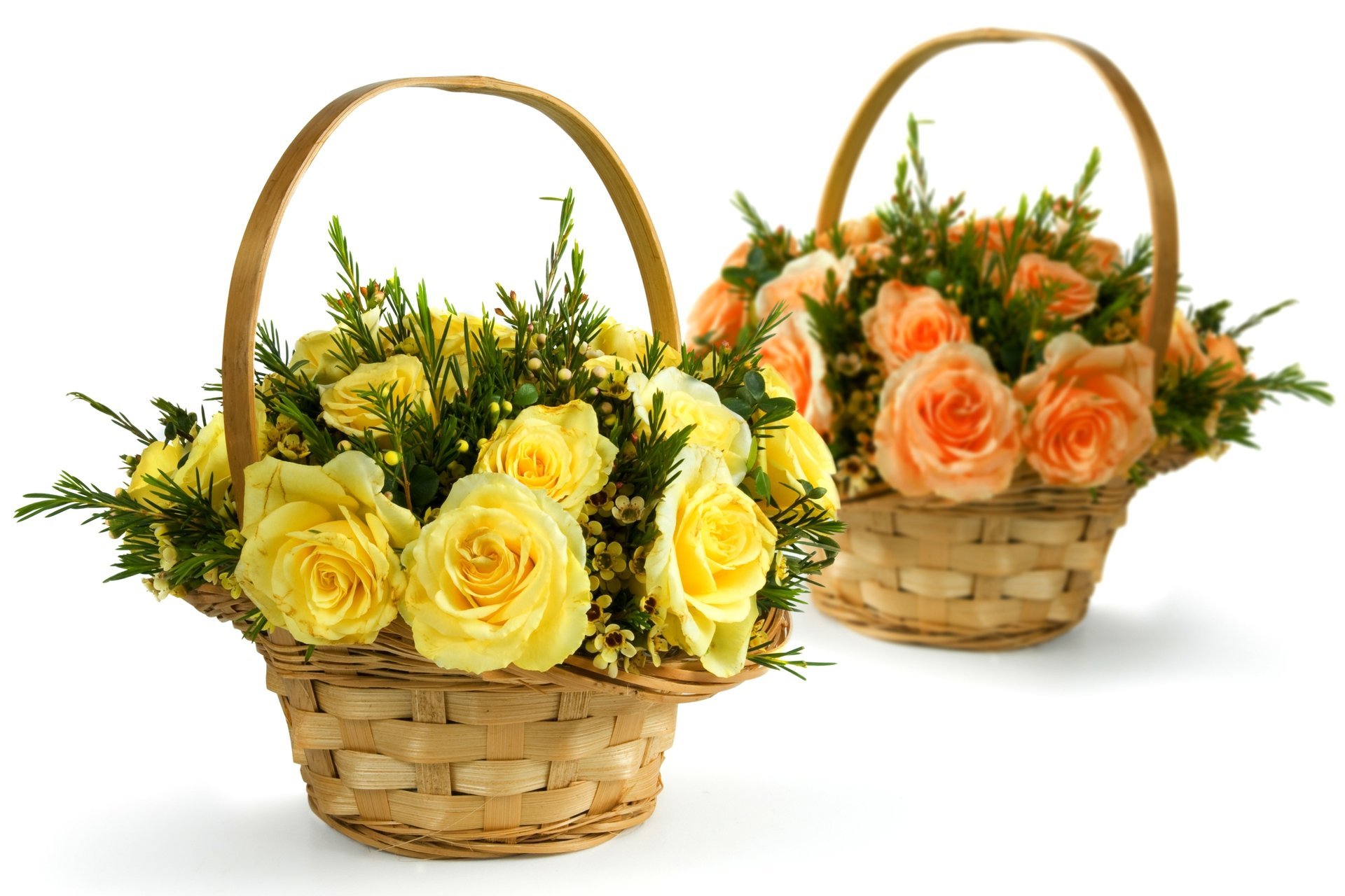 Cute bouquets of roses in wicker baskets