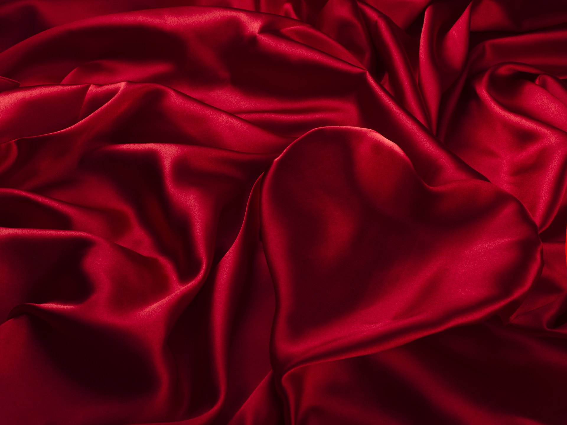 Heart made of red silk fabric with pleats