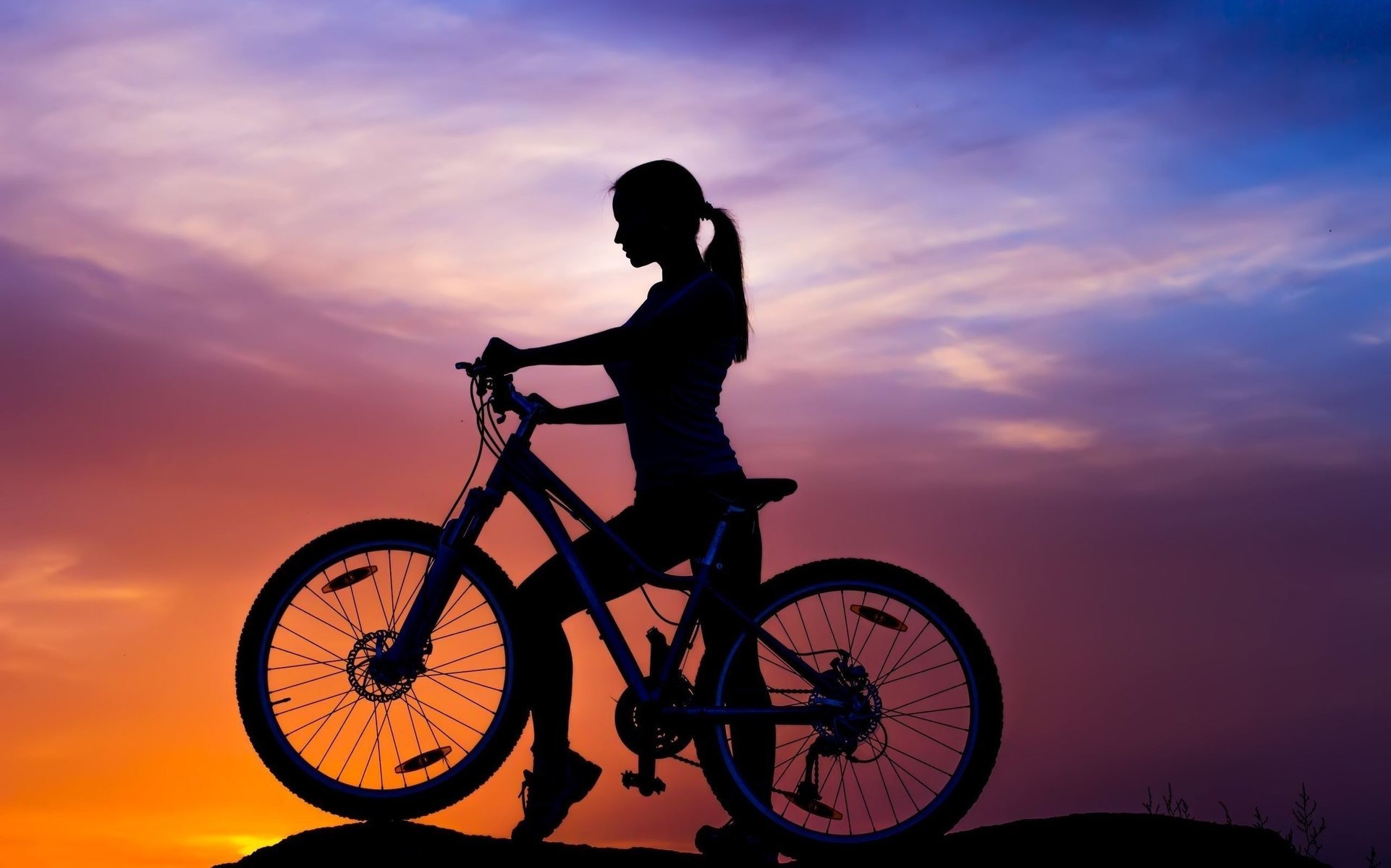 A girl at sunset. Cycling