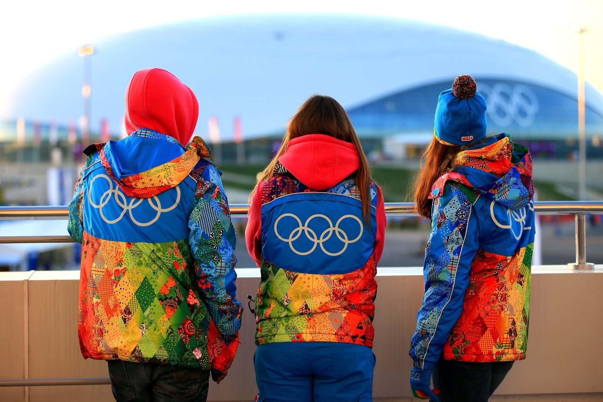 Volunteers in clothes with symbols of the Sochi 2014 Olympics
